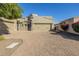 Tan two-story home with a three-car garage and a brick paved driveway at 6202 E Mckellips Rd # 91, Mesa, AZ 85215