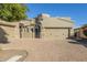 Tan two-story home with a three-car garage and a brick paved driveway at 6202 E Mckellips Rd # 91, Mesa, AZ 85215