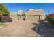 Tan two-story home with a three-car garage and a brick paved driveway at 6202 E Mckellips Rd # 91, Mesa, AZ 85215
