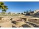 Relaxing fire pit area in the backyard, surrounded by landscaping at 6202 E Mckellips Rd # 91, Mesa, AZ 85215