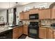 Modern kitchen with granite countertops and black appliances at 6202 E Mckellips Rd # 91, Mesa, AZ 85215