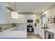 Modern kitchen with white cabinets and quartz countertops at 6411 S River Dr # 11, Tempe, AZ 85283