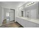 Double vanity bathroom with mirrored sliding doors at 7357 W Canterbury Dr, Peoria, AZ 85345