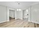 Bright dining room with chandelier and wood-look floors at 7357 W Canterbury Dr, Peoria, AZ 85345