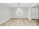 Dining room features a large window with shutters and wood-look floors at 7357 W Canterbury Dr, Peoria, AZ 85345