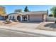 House exterior featuring a two-car garage and desert landscaping at 7357 W Canterbury Dr, Peoria, AZ 85345