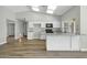 Updated kitchen featuring white cabinets and a breakfast bar at 7357 W Canterbury Dr, Peoria, AZ 85345