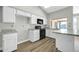 Modern kitchen with white cabinets and granite countertops at 7357 W Canterbury Dr, Peoria, AZ 85345