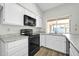 Modern kitchen with white cabinets and stainless steel appliances at 7357 W Canterbury Dr, Peoria, AZ 85345