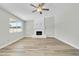Living room with fireplace and wood-look flooring at 7357 W Canterbury Dr, Peoria, AZ 85345