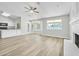Bright living room featuring a fireplace and vinyl plank flooring at 7357 W Canterbury Dr, Peoria, AZ 85345