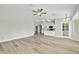 Open living room with wood-look floors and kitchen view at 7357 W Canterbury Dr, Peoria, AZ 85345