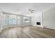 Spacious living room with fireplace and wood-look floors at 7357 W Canterbury Dr, Peoria, AZ 85345