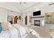 Elegant bedroom with fireplace and built-in shelving at 7635 E Poinsettia Dr, Scottsdale, AZ 85260