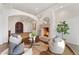 Elegant living room with a stone fireplace, hardwood floors, and comfortable seating at 7635 E Poinsettia Dr, Scottsdale, AZ 85260