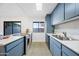 Modern kitchen with stainless steel appliances and blue cabinets at 8837 N New World Dr, Glendale, AZ 85302