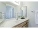 Bright bathroom featuring a vanity with double mirrors, white countertop, and wood-look cabinetry at 11360 E Keats Ave # 78, Mesa, AZ 85209