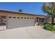 Spacious two-car garage with stylish stone accents and a wide driveway for extra parking at 11360 E Keats Ave # 78, Mesa, AZ 85209