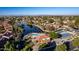 Aerial view of community pool, tennis courts, and lake at 1212 E Butler Dr, Chandler, AZ 85225