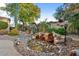 Landscaped backyard with a charming water feature and desert plants at 12385 W Bajada Rd, Peoria, AZ 85383