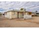 Home's backyard with covered patio and sand at 13001 N 111Th Dr, Youngtown, AZ 85363