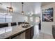 Kitchen island with granite countertop and double sink at 14168 W Georgia Dr, Surprise, AZ 85379