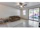 Living room with ceiling fan and sliding glass door to patio at 14168 W Georgia Dr, Surprise, AZ 85379