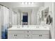 Bathroom boasts a double vanity with white cabinets and a large mirror at 1639 S 82Nd Pl, Mesa, AZ 85209