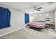 Spacious bedroom with striped bedding and ceiling fan at 1639 S 82Nd Pl, Mesa, AZ 85209