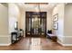 Bright and airy foyer with wood floors and a modern console table at 16575 N 109Th Way, Scottsdale, AZ 85255