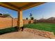 Covered back patio overlooking a green lawn and backyard featuring a charming playhouse at 1844 S 238Th Ln, Buckeye, AZ 85326
