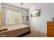 Cozy bedroom with a double bed and dresser, and a large window at 1844 S 238Th Ln, Buckeye, AZ 85326