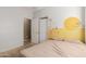 Bedroom with a double bed, closet and yellow and floral wall art at 1844 S 238Th Ln, Buckeye, AZ 85326