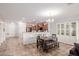 Dining area with table and chairs, open to kitchen and entryway at 1844 S 238Th Ln, Buckeye, AZ 85326