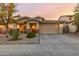 One-story house with tan exterior, two-car garage, and landscaping at 1844 S 238Th Ln, Buckeye, AZ 85326