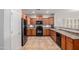 Kitchen with wood cabinets, stainless steel appliances, and tile flooring at 1844 S 238Th Ln, Buckeye, AZ 85326