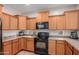 Kitchen boasts wood cabinets, stainless steel appliances, and tile floors at 1844 S 238Th Ln, Buckeye, AZ 85326