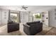 Living room with gray sofas, built in shelving, and sliding glass doors at 1844 S 238Th Ln, Buckeye, AZ 85326