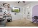 Bright office with a large TV and access to a secondary bathroom at 1844 S 238Th Ln, Buckeye, AZ 85326