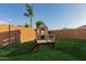 Close-up of a charming playhouse in the backyard, with lush green grass at 1844 S 238Th Ln, Buckeye, AZ 85326