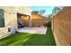 Small backyard with artificial turf, patio, and block wall for privacy at 18611 N 22Nd St # 2, Phoenix, AZ 85024