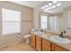 Bathroom with double sinks and wood cabinets at 18611 N 22Nd St # 2, Phoenix, AZ 85024
