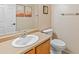 Bathroom with wood vanity, white toilet, and a mirror at 18611 N 22Nd St # 2, Phoenix, AZ 85024