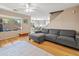 Living room with gray sectional sofa, hardwood floors, and ceiling fan at 18611 N 22Nd St # 2, Phoenix, AZ 85024