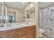 Bathroom with double sinks, a shower, and decorative curtain at 1923 N Cocoa Ct, Casa Grande, AZ 85122