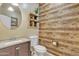 Modern bathroom with wood-look walls and a floating vanity at 1923 N Cocoa Ct, Casa Grande, AZ 85122