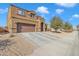Two-story house with brown exterior, attached garage, and driveway at 1923 N Cocoa Ct, Casa Grande, AZ 85122
