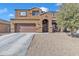 Two-story house with brown exterior, attached garage, and landscaped yard at 1923 N Cocoa Ct, Casa Grande, AZ 85122