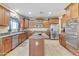 Spacious kitchen with island, stainless steel appliances, and wood cabinets at 1923 N Cocoa Ct, Casa Grande, AZ 85122