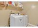 Laundry room with washer, dryer, and shelving at 1923 N Cocoa Ct, Casa Grande, AZ 85122